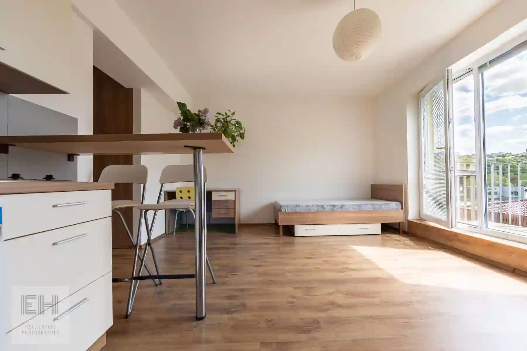 Interiér apartmánu s lôžkom, kuchynským kútom a prístupom na balkón
